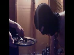 Masked man eating poop like a dog